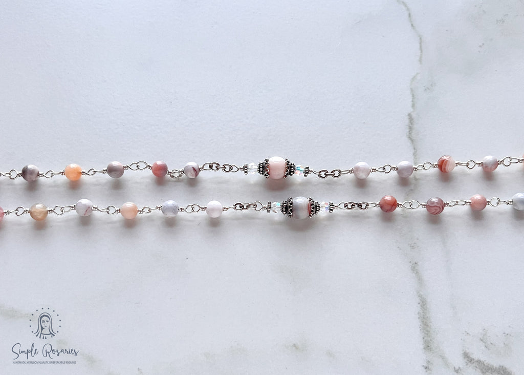 Handmade, heirloom-quality rosary featuring unbreakable pink Botswana agate beads and durable solid sterling silver construction, designed for lasting beauty and spiritual significance
