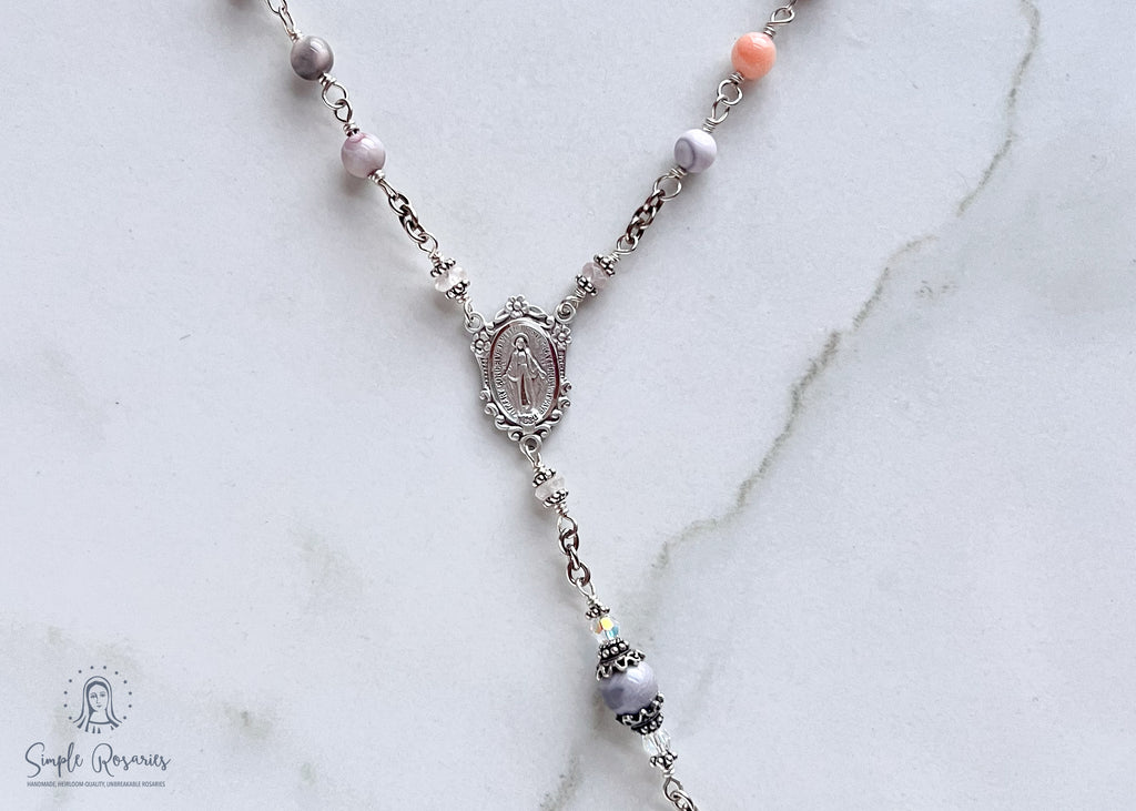 Handmade, heirloom-quality rosary featuring unbreakable pink Botswana agate beads and durable solid sterling silver construction, designed for lasting beauty and spiritual significance