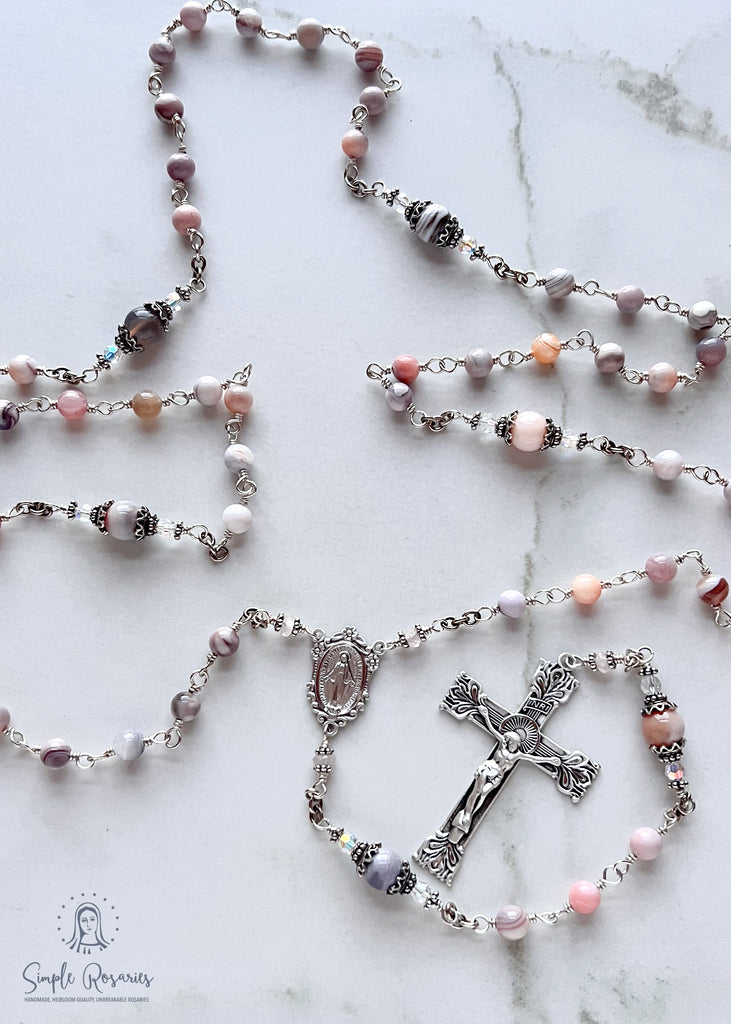 Handmade, heirloom-quality rosary featuring unbreakable pink Botswana agate beads and durable solid sterling silver construction, designed for lasting beauty and spiritual significance