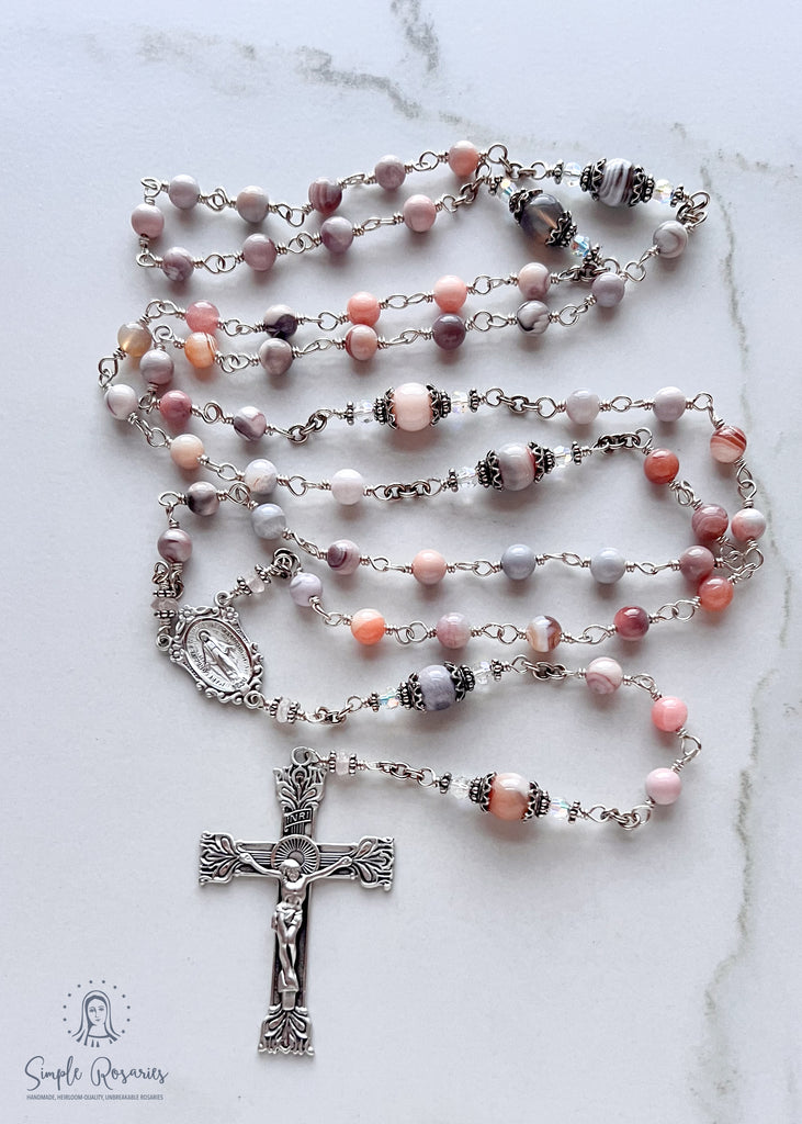 Handmade, heirloom-quality rosary featuring unbreakable pink Botswana agate beads and durable solid sterling silver construction, designed for lasting beauty and spiritual significance