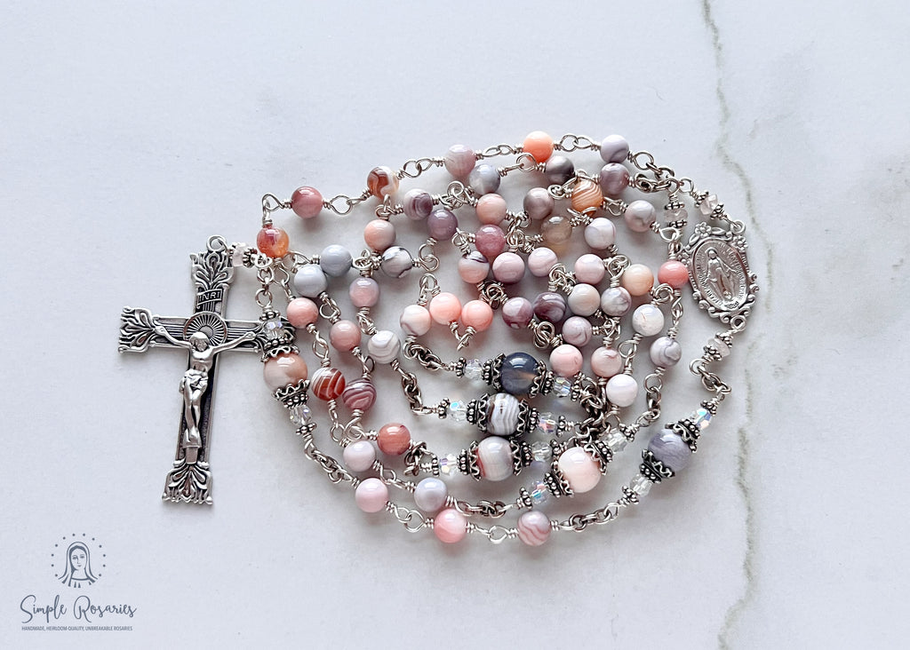 Handmade, heirloom-quality rosary featuring unbreakable pink Botswana agate beads and durable solid sterling silver construction, designed for lasting beauty and spiritual significance