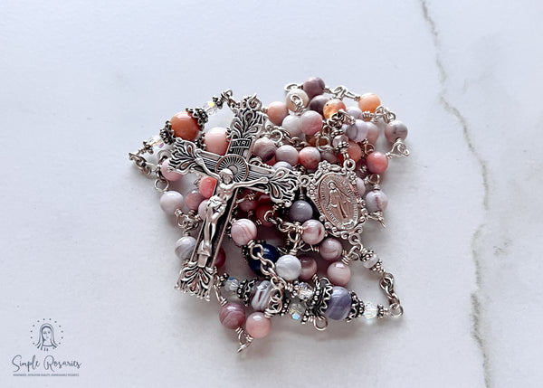 Handmade, heirloom-quality rosary featuring unbreakable pink Botswana agate beads and durable solid sterling silver construction, designed for lasting beauty and spiritual significance