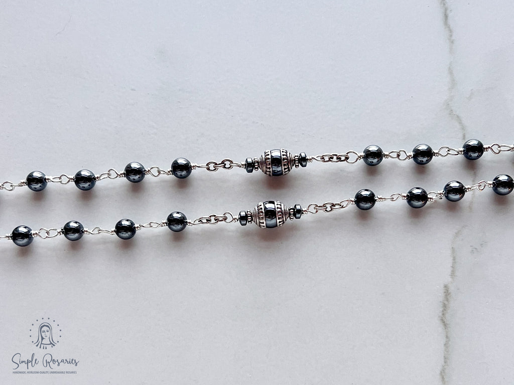 Handmade, heirloom-quality rosary featuring unbreakable hematite beads and durable solid sterling silver construction, designed for lasting beauty and spiritual significance