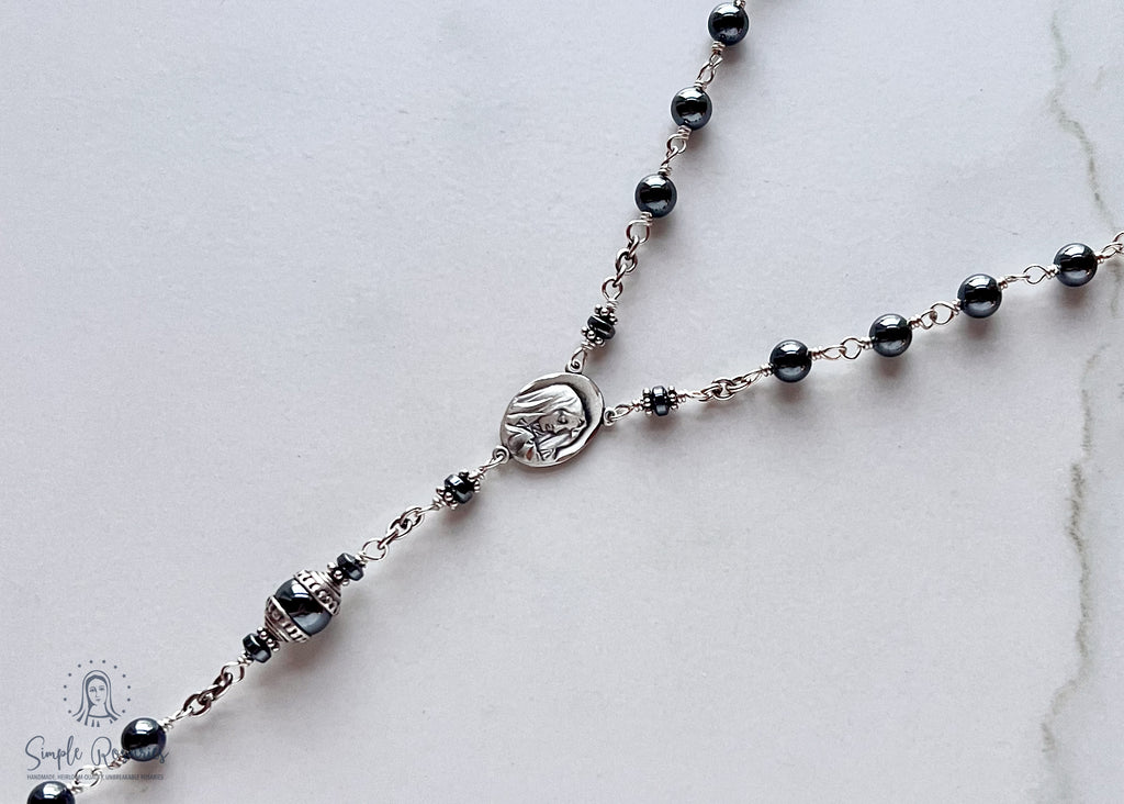Handmade, heirloom-quality rosary featuring unbreakable hematite beads and durable solid sterling silver construction, designed for lasting beauty and spiritual significance