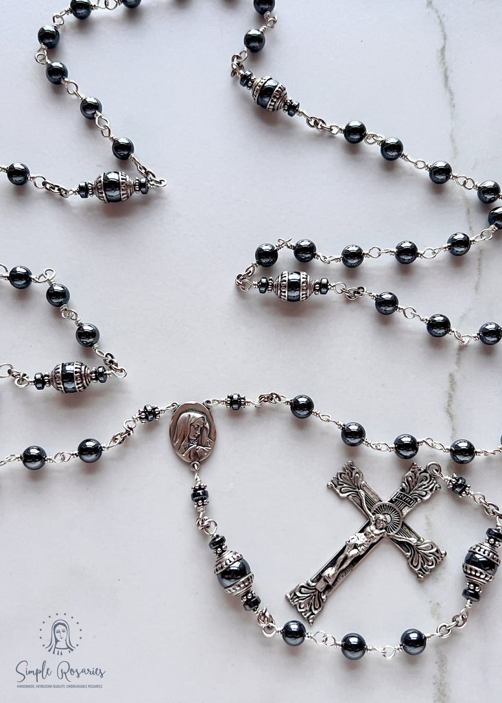 Handmade, heirloom-quality rosary featuring unbreakable hematite beads and durable solid sterling silver construction, designed for lasting beauty and spiritual significance