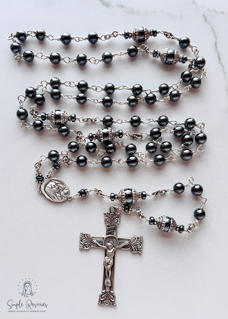 Handmade, heirloom-quality rosary featuring unbreakable hematite beads and durable solid sterling silver construction, designed for lasting beauty and spiritual significance