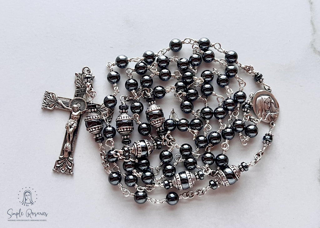 Handmade, heirloom-quality rosary featuring unbreakable hematite beads and durable solid sterling silver construction, designed for lasting beauty and spiritual significance