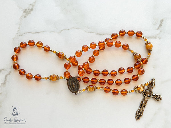 handmade heirloom quality baltic amber and bronze rosary strung on durable soft flex wire, orange and gold