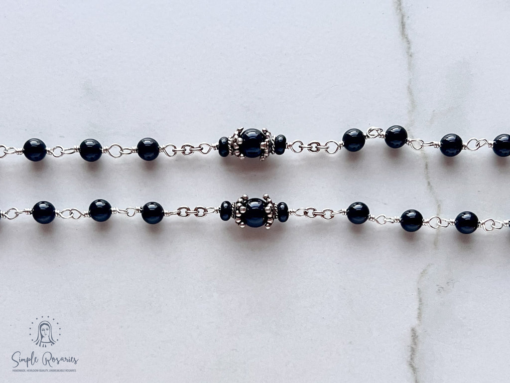 Handmade, heirloom-quality rosary featuring unbreakable onyx beads and durable solid sterling silver construction, designed for lasting beauty and spiritual significance
