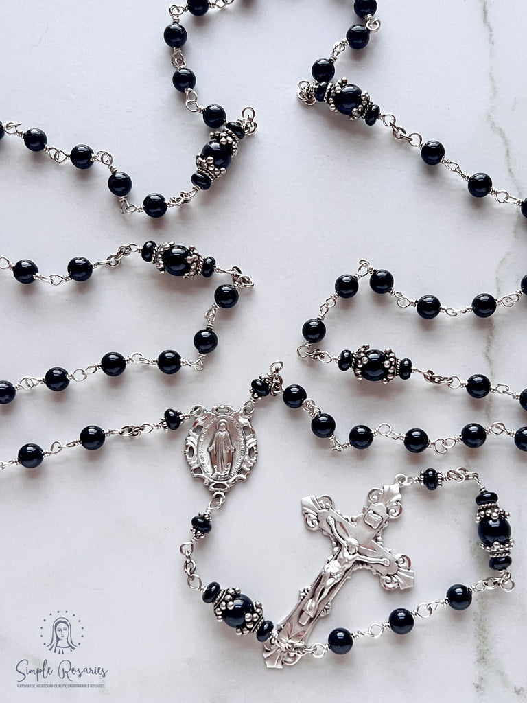 Handmade, heirloom-quality rosary featuring unbreakable onyx beads and durable solid sterling silver construction, designed for lasting beauty and spiritual significance
