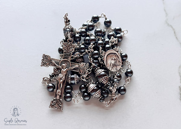 Handmade, heirloom-quality rosary featuring unbreakable hematite beads and durable solid sterling silver construction, designed for lasting beauty and spiritual significance