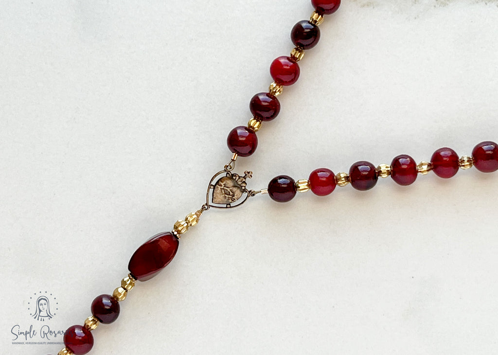 handmade heirloom quality cranberry horn rosary with solid bronze accents, centerpiece and crucifix