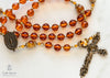 handmade heirloom quality baltic amber and bronze rosary strung on durable soft flex wire, orange and gold