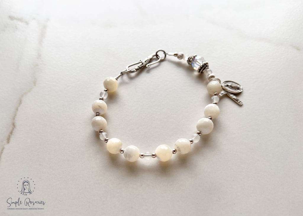 handmade, heirloom quality rosary bracelet with mother of pearl and Swarovski crystal, solid sterling silver accents, crucifix and miraculous medal