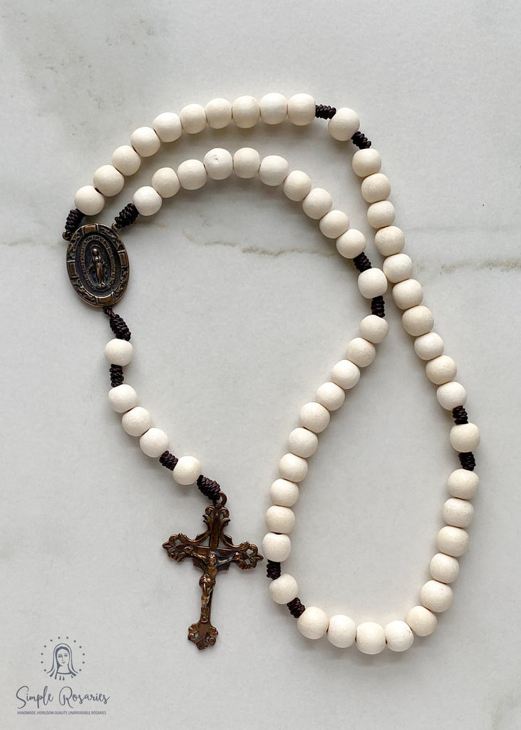 handmade, heirloom-quality, unbreakable rosaries, solid bronze, miraculous medal and crucifix, white wood and cord rosary